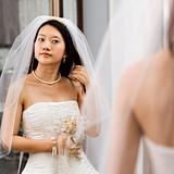 Bride looking at mirror.
