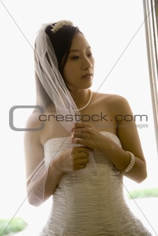 Bride holding veil.