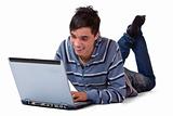 Youn happy male teenager working on computer laptop