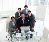 Senior businessman working with his team at a computer