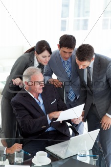 Manager showing document to his team