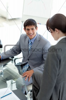 Young businessman sitting at a conference table
