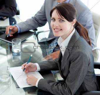 Smiling businesswoman studying a document in a meeting