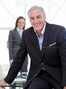 Senior businessman sitting on a conference table