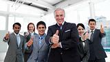 Happy multi-ethnic business team with thumbs up