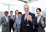 Happy diverse business group toasting with Champagne
