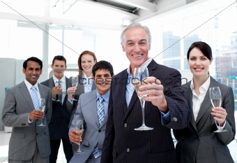 Happy diverse business group toasting with Champagne