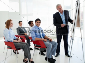Portrait of a senior businessman giving a conference