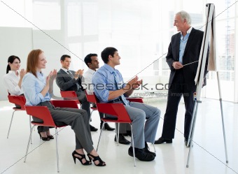 Business people applauding at the end of a conference
