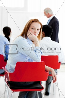 Young businesswoman bored at a conference 