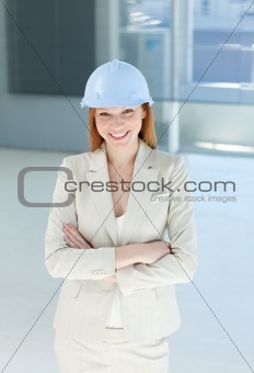 Smiling female architect with folded arms 
