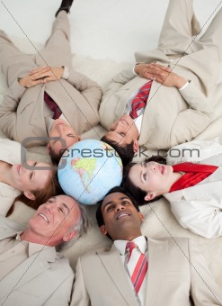 International business people lying on the floor around a terres