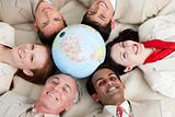 A diverse business people lying on the floor around a globe