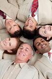 Multi-ethnic business team lying in a circle 