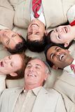 Laughing Business team lying in a circle
