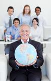 Smiling businessman holding a terrestrial globe 