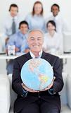 Senior manager holding a terrestrial globe
