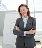 Attractive businesswoman with folded arms at a presentation
