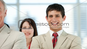 Smiling young businessman with his colleagues