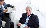 Senior businessman drinking coffee and waiting for a job intervi