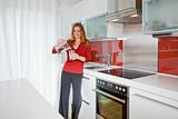 young beautiful woman standing in modern kitchen interior