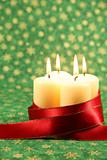 Candles with ribbon on Christmas background