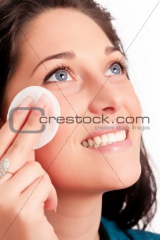 Young woman removing makeup