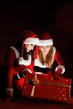 two woman in Santa costume opening christmas gift
