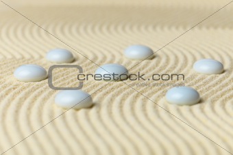 White drops on surface of yellow sand - abstract composition