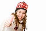 Young happy smiling woman with cap and scarf shows thumb up