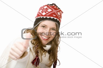 Young happy smiling woman with cap and scarf shows thumb up