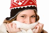 Young happy smiling woman with cap holding scarf over mouth