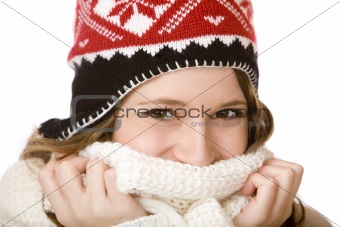Young happy smiling woman with cap holding scarf over mouth