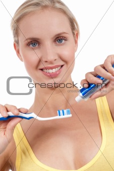 Smiling young woman with toothbrush