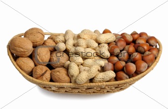 Set of nuts in a wicker basket, isolated
