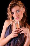 Beautiful woman with a glass of champagne on black background