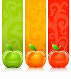 three coloured apples on decorative background
