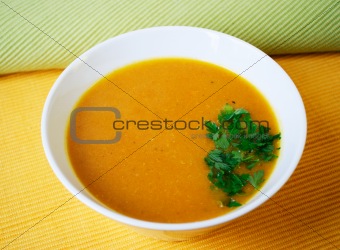Pumpkin soup in a plate with parsley