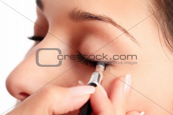 Woman applying eyeshadow makeup 