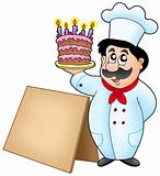 Chef holding cake with wooden table