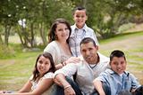 Happy Hispanic Family Portrait In the Park.