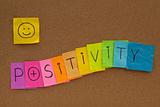 positivity concept with smiley on cork board