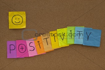 positivity concept with smiley on cork board