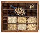 variety of rice grains in vintage wooden drawer with scoop