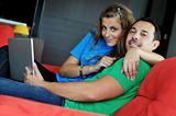 happy couple have fun and work on laptop at home