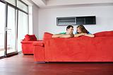 happy couple relax on red sofa