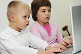 childrens have fun and playing games on laptop computer