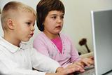 childrens have fun and playing games on laptop computer