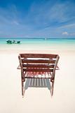 a beach with a lonely chair