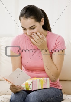 Young Woman Opening Gift